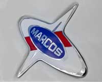 Фото логотипа (эмблемы, знака, фирменной надписи) легковых автомобилей марки Marcos «Маркос»